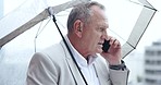 Phone call, senior and business man with umbrella for rain weather in urban city. Smartphone, talk and person with parasol outdoor for water, shield or protection in winter for ceo speaking on mobile