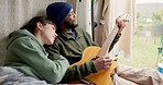 Couple, guitar and singing in camper, vacation and relax together with music, care and morning by lake. Man, woman and interracial love with art for peace with melody, harmony and rv holiday in woods