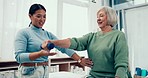 Senior care, help and physiotherapist with woman, dumbbell and healthcare at nursing home. Physio, exercise and retirement, fitness caregiver coaching elderly patient for mobility training in clinic.
