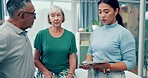 Physiotherapy conversation, couple and a doctor with a tablet for a consultation and retirement healthcare. Planning, interracial man and woman speaking to a physiotherapist with tech for advice