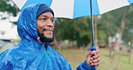 Rain, umbrella and happy with black man in nature for travel, hiking and vacation adventure. Calm, freedom and winter storm with person and relax in countryside woods for health, camping and trekking