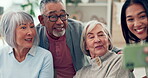 Senior people, friends and happy selfie with a caregiver in a nursing home. Elderly women and a man smile together for social media, profile picture or memory with a young person in retirement