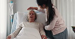 Woman, nurse and senior patient in elderly care on bed for healthcare, support or rest at the hospital. Female volunteer, caregiver or physiotherapist helping mature person in comfort at the clinic