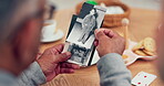 Hands, picture and memory with senior friends thinking about the past while in a nursing home. History, vintage and retirement with an elderly group holding a photograph closeup to remember life