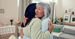 Family, love and a senior asian woman hugging her daughter in the living room of a home during a visit. Retirement, smile and an adult child embracing her happy mother together in an apartment