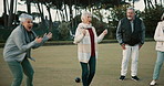 Bowls, celebration and hugging with senior friends outdoor, cheering together during a game. Motivation, support or applause and a group of elderly people clapping while having fun with a hobby