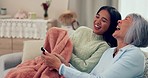 Senior mom, woman and sofa for watching tv, remote and helping hand with button, choice or comic laugh. Television, happy mother and daughter with guide, relax or funny together in Asian family house