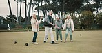 Senior man, team and bowling on grass with miss, fail or support for fitness, sport or game in retirement. Teamwork, group and elderly women with metal ball, exercise or kindness for training on lawn