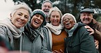 Happy, selfie and senior friends in a park while walking outdoor for fresh air together. Diversity, smile and group of elderly people in retirement taking picture and bonding in a forest in winter.