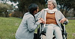 Nurse support woman with disability in park for healthcare, trust and care in retirement. Caregiver talking to happy senior patient in wheelchair for rehabilitation, therapy or conversation in garden