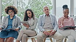 Business people, diversity and waiting room in row for hiring, recruiting or opportunity at the office. Group of employees sitting on chairs in line for job, career or meeting together at workplace