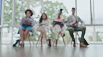 Business people, row and sitting in waiting room for hiring, recruiting or opportunity against a blurred background. Group of employees in relax for job or career meeting in line together at office