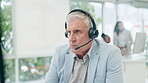 Headset, computer and a man in a call center for customer service, telemarketing and crm. Serious male consultant or agent talking for technical support, sales or help desk conversation or advice