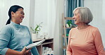 Physiotherapist, tablet or happy senior woman talking in consultation for physical therapy or medical results.  Smile, elderly or mature patient speaking to woman for good news in rehabilitation