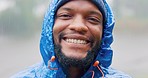 Face, happy and a black man hiking in the rain, outdoor in nature for travel, tourism or adventure. Portrait, winter and smile with a wet young hiker in the forest or woods for freedom and vacation