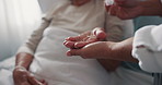 Hands, retirement and caregiver with senior woman taking drugs for healthcare with wellness. Medication, elderly female and nurse in closeup for medical treatment and vitamins with nurse for support.