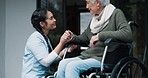 Wheelchair, retirement or assisted living and a senior woman with a disability in her nursing home. Healthcare, nurse and support with a female caregiver talking to an elderly patient in a house