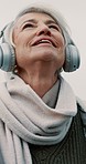 Old woman, thinking with headphones and music outdoor, walking and wellness with audio streaming and retirement. Podcast, listen to radio and inspiration, female person and memory with technology