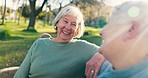 Happy, talking and a senior couple at a park for conversation, retirement date and love. Smile, care and an elderly man and woman on a bench in nature for communication, bonding or together in summer