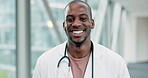 Face, happy doctor and black man in hospital for healthcare, wellness and insurance. African medical professional, portrait and surgeon smile, expert worker or employee from Nigeria in health clinic