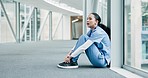 Sad, nurse  and woman by window with stress and anxiety from bad news. Hospital, female medic professional and burnout from work of clinic employee with mental health problem sitting on ground
