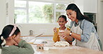 Baking, family help and learning of kids with mother showing cookie dough roll in a kitchen. Home, support and mama with cooking and children with kid teaching and food to bake dessert in a house