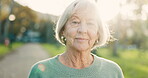 Smile, senior and face of a woman in nature for a walk, break or relax in retirement. Summer, park and portrait of an elderly person in a nursing home garden or park for fresh air or outdoor peace