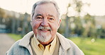 Happy, senior man and portrait outdoor in a park with happiness, positive mindset and a smile. Face of elderly male person in nature, forest or woods for fresh air, health and wellness in retirement