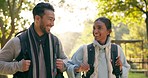 Hiking, laugh and couple in a forest walking, talk and hand pointing to view outdoors. Nature, walk and woman with man in the woods for hike, speaking and explore, adventure and backpacking travel