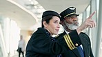 Travel, pilot and air hostess in discussion at the airport before boarding a flight in the city. Conversation, communication and hospitality air crew team talking about a strategy in urban town hotel