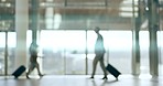 Travel, airport and business people on a mission with luggage in a terminal for an international trip. Corporate, transport and flight with a group of professional people walking for global departure