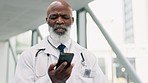 Phone call, telehealth and senior doctor walking in the hospital corridor talking on a mobile. Technology, career and African male healthcare worker doing an online medical consultation on cellphone.