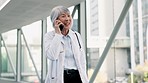 Phone call, medical and female doctor in the hospital walking in corridor talking on mobile. Technology, professional and senior healthcare worker doing online telehealth consultation on a cellphone.