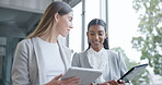 Business women, walking and talking with a tablet in an office with ideas, smile and strategy. Corporate people, partner or friends with diversity, technology or collaboration discussion at workplace