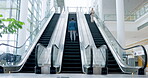 Escalator, greeting and business people travel to work ready for corporate company tradeshow convention. Airport, happy and man employee at an international destination or terminal for a trip