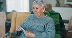 Senior woman, photograph and memory on a home sofa for nostalgia, history and to remember. An elderly female person with pictures while thinking of old album, nostalgia and photography in retirement