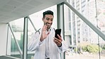 Video call, telehealth and doctor on a phone in the hospital walking in the corridor talking. Technology, mobile and young male healthcare worker doing an online medical consultation on a cellphone.