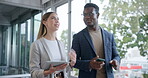 Business people, walking and talking with a technology in an office with ideas, smile and strategy. A corporate man and woman partner with diversity, tablet and a phone for a discussion at workplace