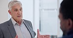 Business people, senior man and boss talking to staff in conversation, communication or collaboration of mentor, leadership or training. Manager, executive CEO or chat of corporate feedback in office