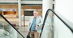 Luggage, escalator and senior man in the airport for a business trip, convention or weekend. Serious, waiting and professional mature male lawyer on a moving staircase in a travel center for work.