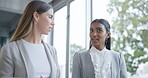 Business women, walking and talking in an office with ideas, smile and strategy. Corporate people, partner or friends together with diversity, tablet and discussion or chat at coworking workplace