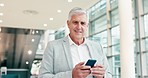 Boss, face of man and walking with phone for social network, mobile app or trading stocks online in office building. Portrait of happy senior CEO reading stock market news on smartphone tech in lobby