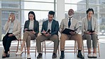 Recruitment, row and business people waiting for a job interview in the office checking their cv. Hiring, queue and corporate employees in a line with a notebook for a meeting in modern workplace.