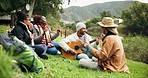 Dance, guitar and friends camping at lake, laughing and freedom for happy celebration in nature. Forest, outdoor adventure and singing to music, men and women on grass on summer weekend camp together