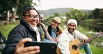 Forest, selfie and friends at lake with guitar, happy and enjoying music or camping in nature. Smartphone, profile picture and group of people relax in woods, fun and enjoy freedom at river with beer