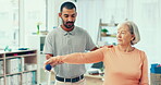 Physiotherapy, stretching and man with a senior woman for rehabilitation, strong arm or exercise. Support, fitness and male physiotherapist with an elderly patient for injury recovery and healthcare