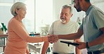 Physiotherapy, handshake and man with senior couple greeting for medical care, consulting and wellness. Chiropractor with man and woman on tablet for physical therapy, rehabilitation and healthcare