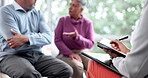 Hand, counseling and a senior couple talking to a therapist about marriage, problems or issues in an office. Support, psychology and a consulting writing in her notebook during a therapy session