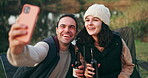 Selfie, camping and couple with beer by a river for a celebration and to update social media of a vacation together. Internet, travel and people happy for a online picture in the outdoor woods