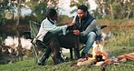 Couple, camping and relax with dog, lake and forest with smile, bonfire and love for holiday in nature. Man, woman and pet animal with stroke, care and happy together in woods, field or countryside